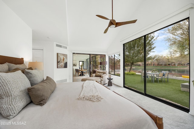 bedroom with access to exterior, a water view, and high vaulted ceiling