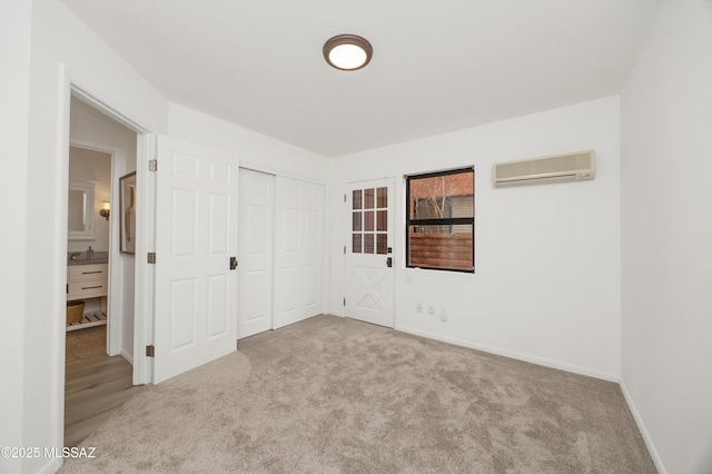 unfurnished bedroom with a closet, sink, light carpet, and a wall mounted AC