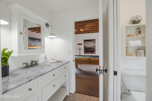 bathroom featuring vanity and toilet