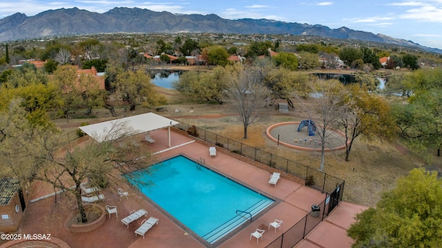 birds eye view of property with a water and mountain view