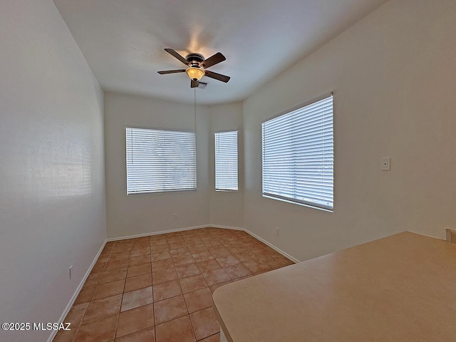 empty room with light tile patterned flooring and ceiling fan