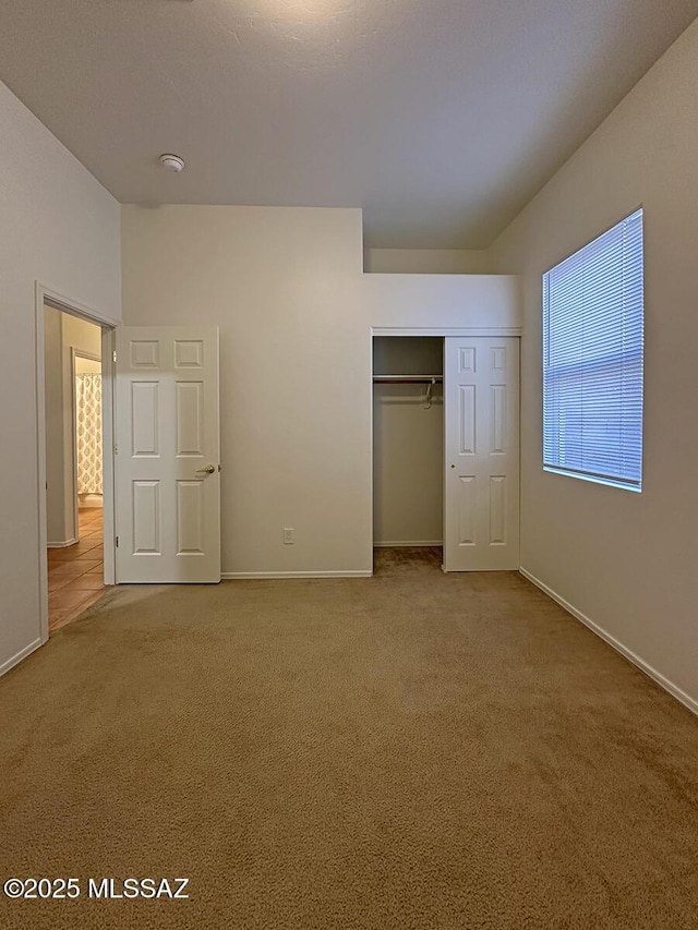 unfurnished bedroom featuring a closet and carpet