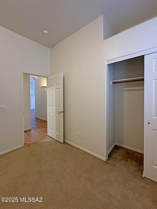 unfurnished bedroom featuring a closet and carpet flooring