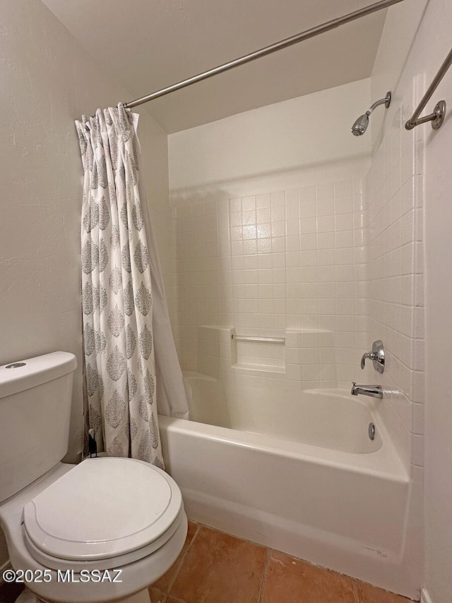 bathroom with tile patterned floors, shower / bath combination with curtain, and toilet