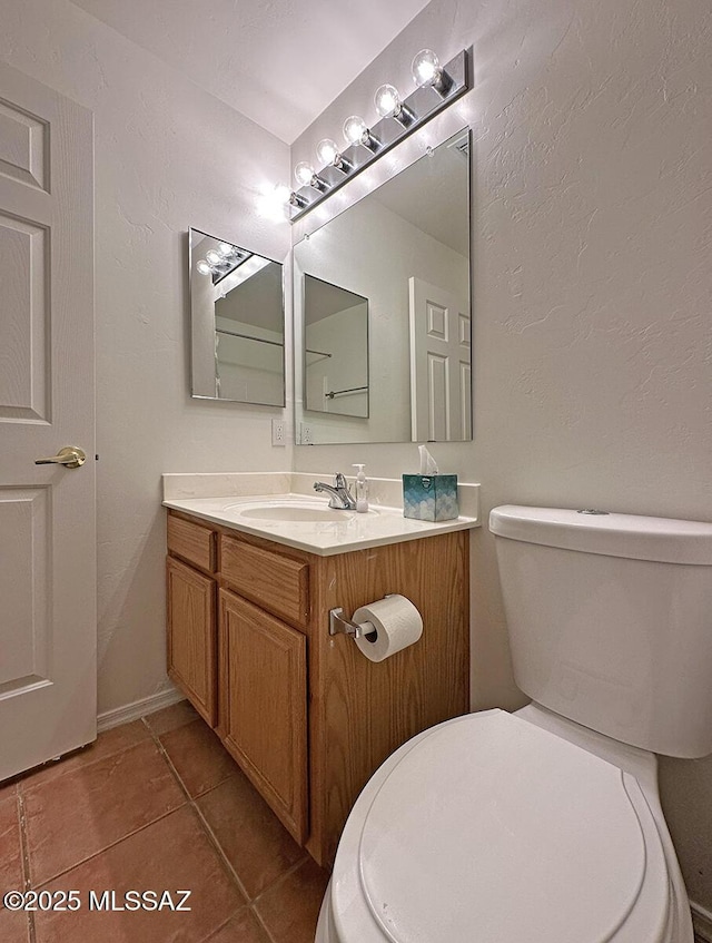 bathroom featuring vanity, toilet, and tile patterned flooring