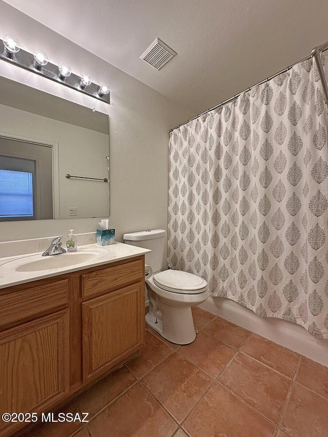 bathroom with vanity, tile patterned floors, and toilet