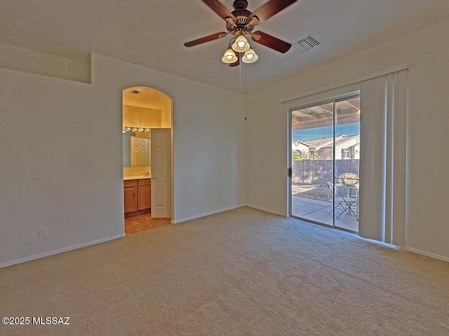 carpeted empty room featuring ceiling fan