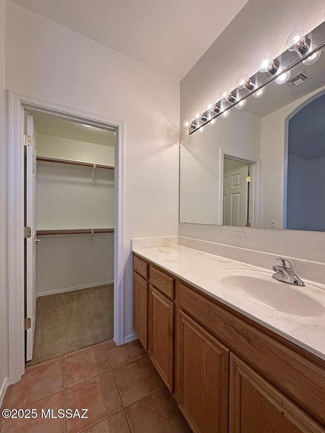 bathroom with tile patterned floors and vanity