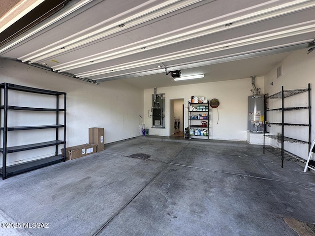 garage featuring water heater and a garage door opener