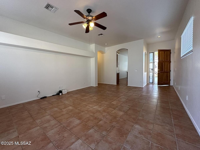 spare room featuring tile patterned floors and ceiling fan