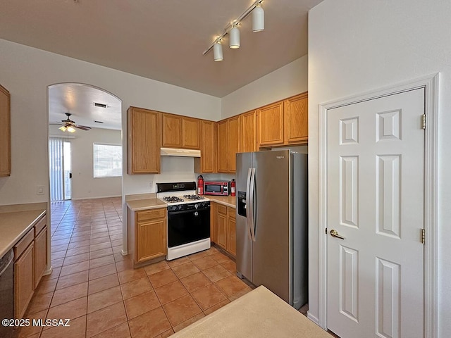 kitchen featuring light tile patterned flooring, dishwasher, ceiling fan, stainless steel fridge with ice dispenser, and gas range