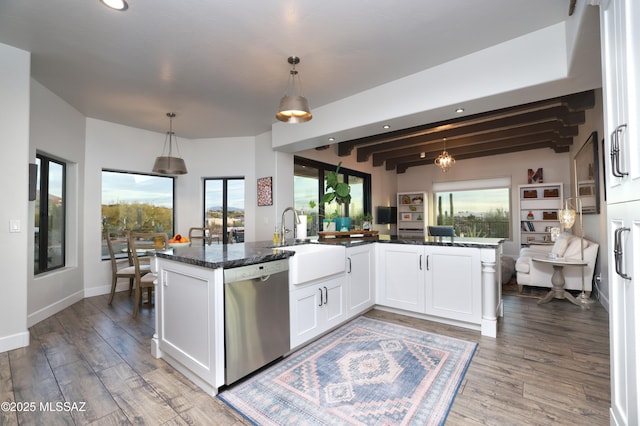 kitchen featuring sink, beam ceiling, dishwasher, white cabinetry, and hanging light fixtures