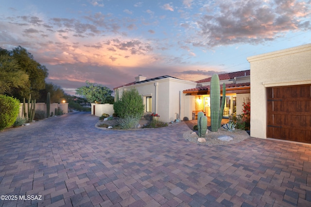 property exterior at dusk featuring a garage