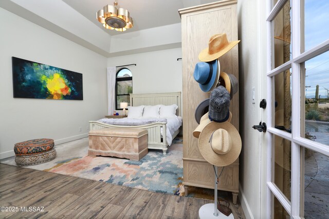 bedroom featuring dark hardwood / wood-style flooring and a notable chandelier