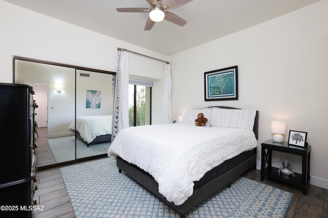 bedroom featuring ceiling fan and dark wood-type flooring