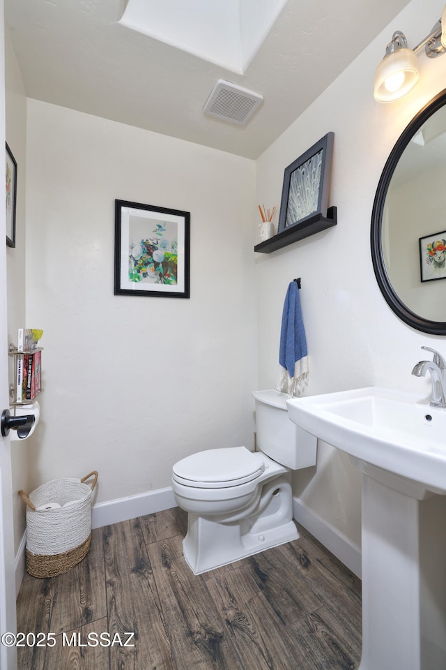 bathroom featuring sink, wood-type flooring, and toilet