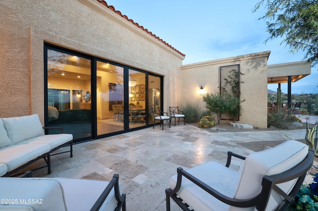 patio terrace at dusk featuring an outdoor living space