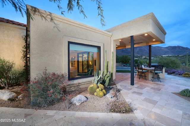 exterior space with a mountain view and an outdoor bar