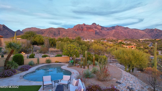 view of pool with a mountain view and a patio area