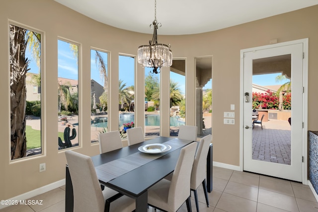 tiled dining area with an inviting chandelier