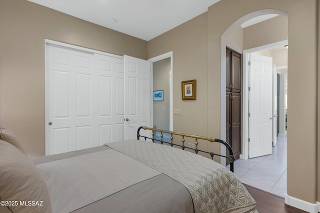 tiled bedroom featuring a closet