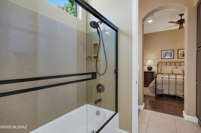 bathroom featuring tile patterned flooring, ceiling fan, and enclosed tub / shower combo