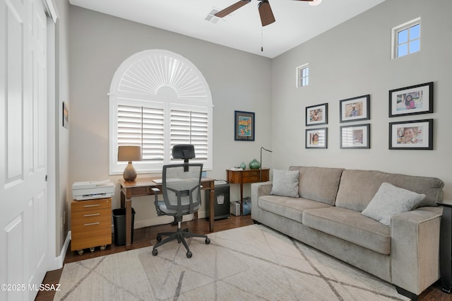 office space with ceiling fan and light wood-type flooring