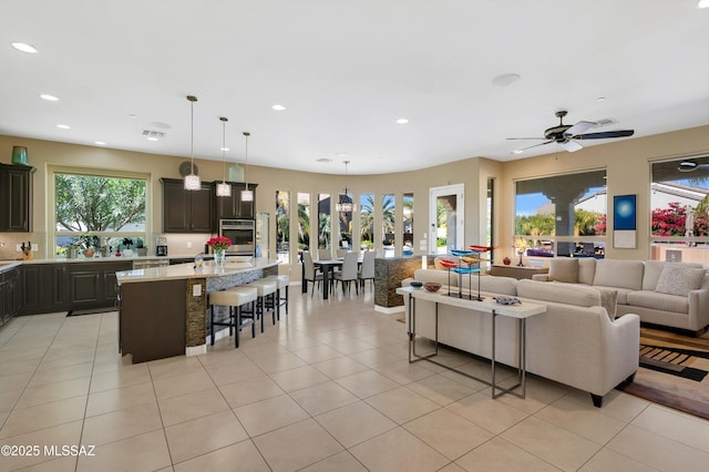 tiled living room featuring ceiling fan