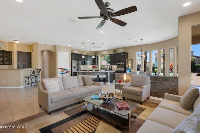 living room featuring ceiling fan and light tile patterned flooring