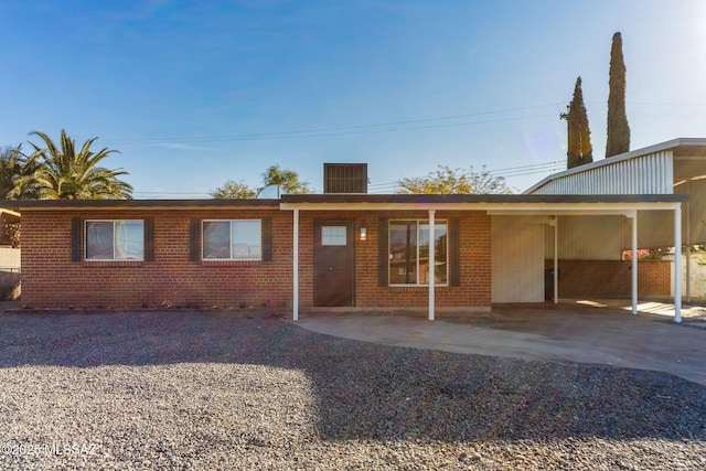 back of house featuring a carport