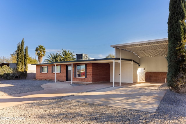 view of front facade with central air condition unit and a carport