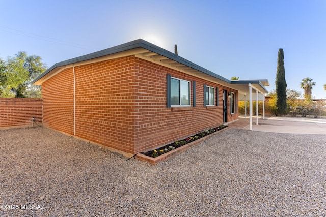 view of property exterior with a patio area