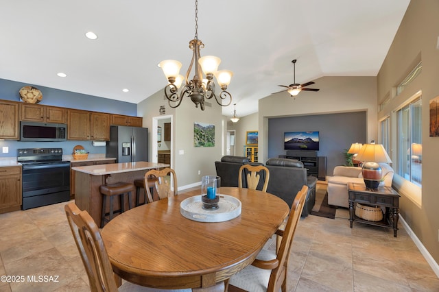 dining room with vaulted ceiling and ceiling fan with notable chandelier