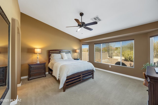 bedroom featuring ceiling fan, light colored carpet, and lofted ceiling