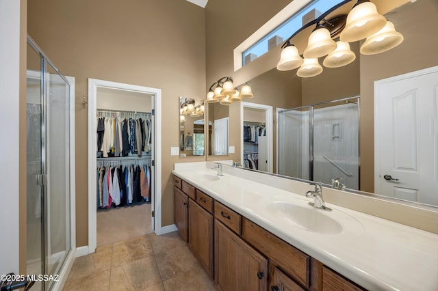 bathroom with walk in shower, a chandelier, and vanity