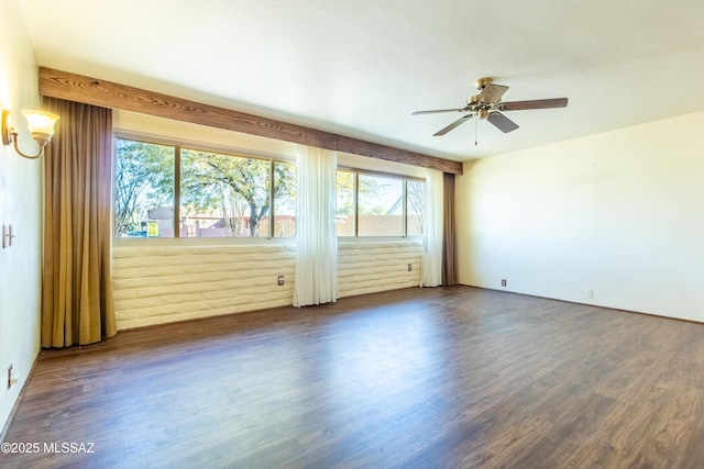 spare room featuring ceiling fan and dark hardwood / wood-style flooring