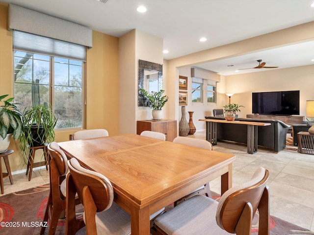 tiled dining area with ceiling fan