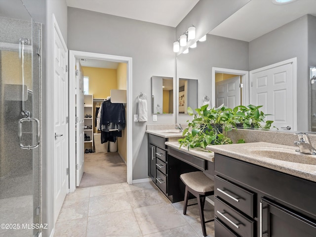 bathroom featuring vanity and a shower with shower door