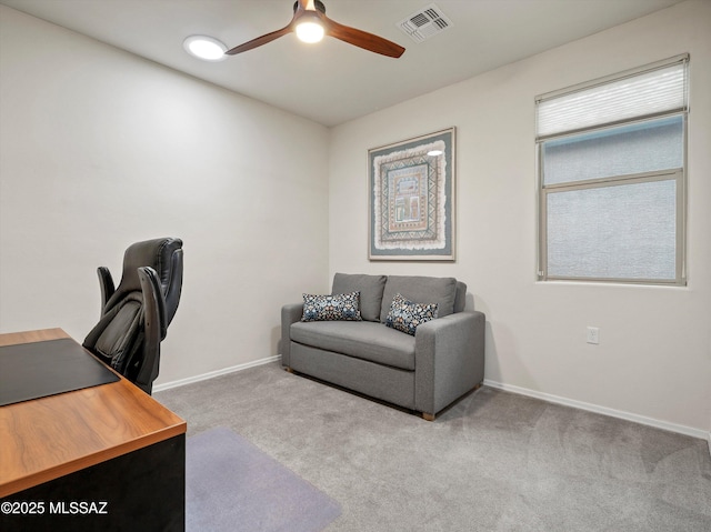 carpeted office featuring ceiling fan