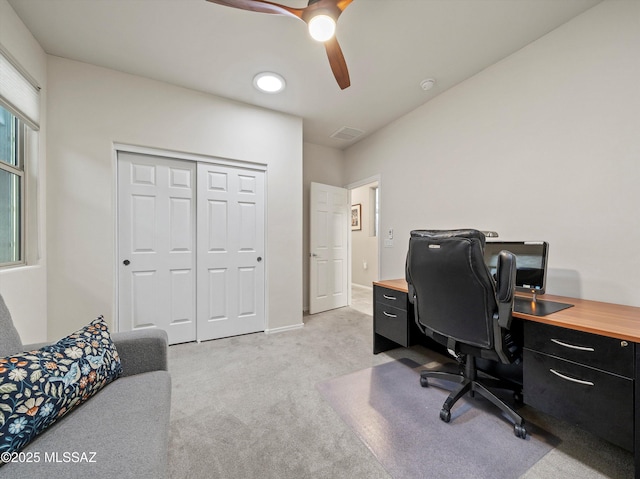 carpeted home office featuring ceiling fan