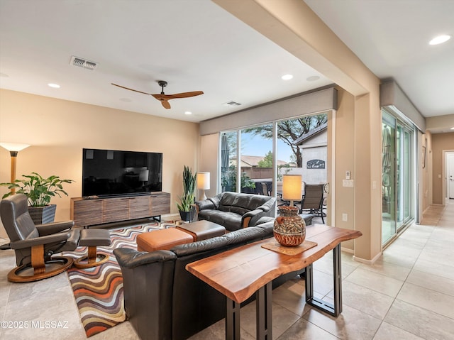 living room with ceiling fan and light tile patterned flooring