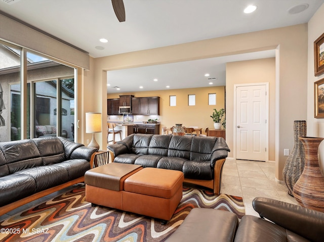 living room with ceiling fan and light tile patterned floors