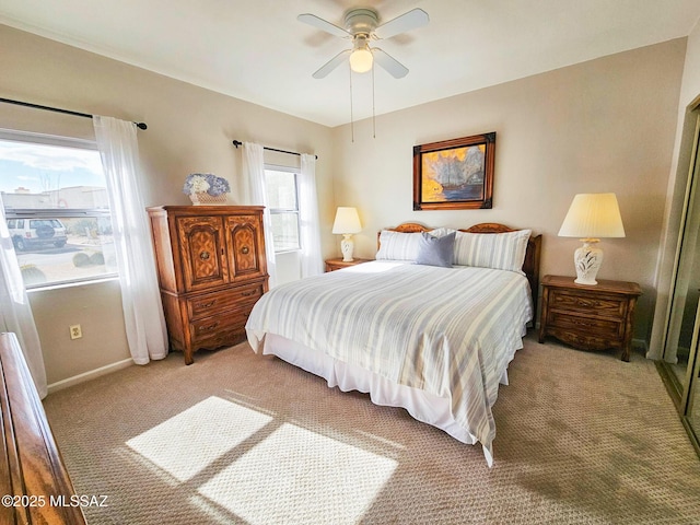 bedroom with light carpet and ceiling fan