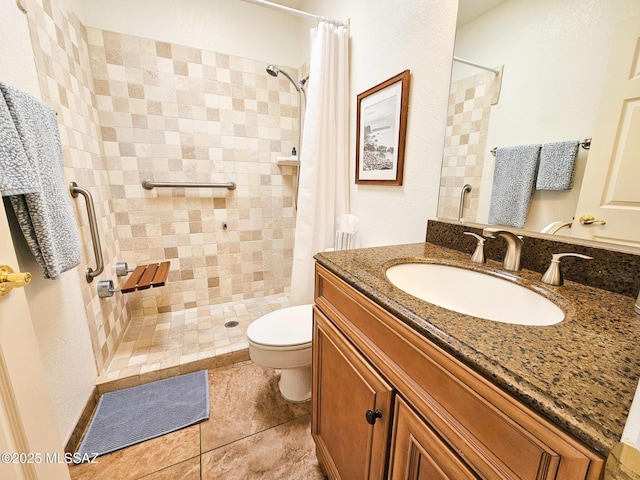 bathroom featuring tile patterned floors, vanity, toilet, and curtained shower