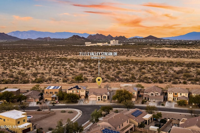 aerial view at dusk featuring a mountain view