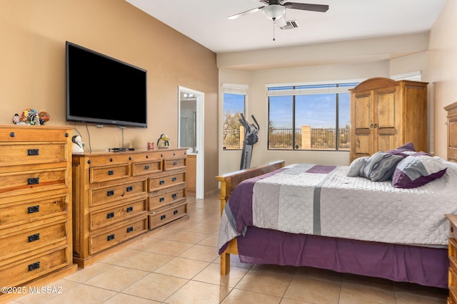 bedroom featuring light tile patterned floors, ceiling fan, visible vents, and ensuite bathroom