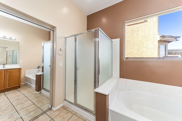 full bath featuring a stall shower, tile patterned flooring, a garden tub, and vanity