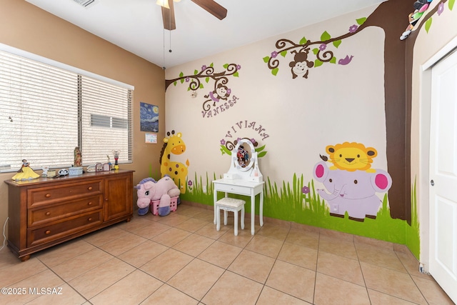 rec room with visible vents, a ceiling fan, and light tile patterned flooring