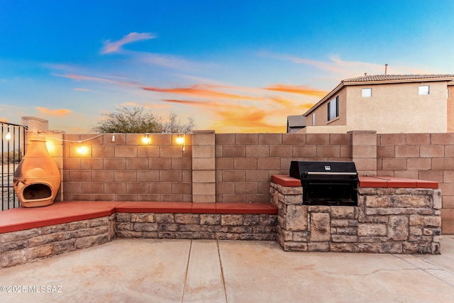 view of patio featuring grilling area and fence