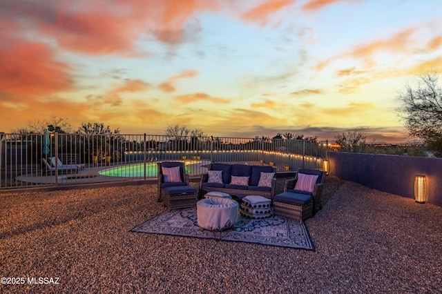 patio terrace at dusk featuring a swimming pool